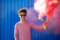 Young black hipster man holding pink smoke bomb Royalty Free Stock Photo