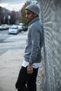 A young, black hipster poses for a candid photograph in NYC