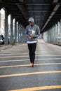 A young, black hipster poses for a candid photograph in NYC