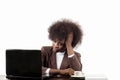 Young black Hispanic business woman, with afro hair, with worried gesture looking at her laptop, in white background Royalty Free Stock Photo