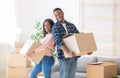 Young black homeowners with carton boxes feeling happy in their new home on moving day, panorama Royalty Free Stock Photo