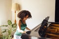 Young black lady playing a piano