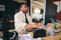 Young Black Male Advertising Marketing Or Design Creative In Office Sitting At Desk Working On Computer Royalty Free Stock Photo