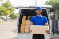 Young black male courier happy delivery with technology, tracking and courier service concept.