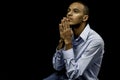 Young black male praying