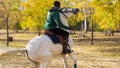 Young black male riding a white horse at park in autumn Royalty Free Stock Photo