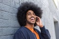 Young black man with afro talking on mobile phone Royalty Free Stock Photo