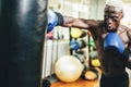 Young black man boxing inside training fitness gym club - African fit boxer doing workout session - Sport, self defense and