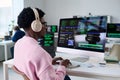 Young Black Man Coding Software on Computer Monitors in Office Setting Royalty Free Stock Photo