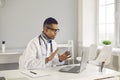 Young black man doctor therapist sitting and talking online with patient Royalty Free Stock Photo