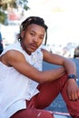 Young black man with dreadlocks sitting outside Royalty Free Stock Photo