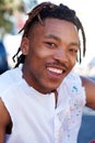 Young black man with dreadlocks smiling outside Royalty Free Stock Photo