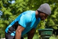 Young black man drinking water from a water fountain