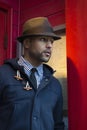 Young Black Man with Fedora in Red Doorway Royalty Free Stock Photo