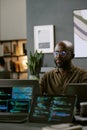 Young Black Man Focusing on Software Development in Contemporary Office Royalty Free Stock Photo