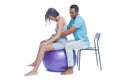 A young black man helps his white wife with birth pain with a ball. Partnered birth, partnered delivery. Isolated white