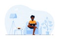 Young black man at home sitting in chair and working on computer Royalty Free Stock Photo