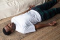 Young black man lying in Dead Body exercise or Corpse pose with his eyes closed, Savasana pose Royalty Free Stock Photo