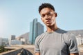 Young black man and portrait on bridge with buildings, sky and city for running. Man, fitness and workout in urban