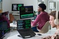 Young Black Man Reviewing Programming Code on Multiple Computer Screens Royalty Free Stock Photo