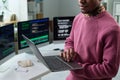 Young Black Man Reviewing Software Code on Laptop in Technology Office Royalty Free Stock Photo