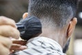 Young black man shaving in barbershop