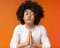 Young black man showing clasped hands in pleading gesture Royalty Free Stock Photo