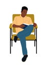 Young black man sitting on armchair, reading book. Royalty Free Stock Photo