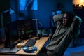 Young Black Man Relaxing While Coding on Computer Monitors at Night Royalty Free Stock Photo