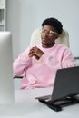 Young Black Man Sitting at Desk Using Computer and Looking Thoughtful Royalty Free Stock Photo