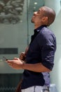 Young black man smiling with mobile phone in the city Royalty Free Stock Photo