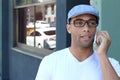 Young black man smiling and talking on mobile phone outside with copy space Royalty Free Stock Photo