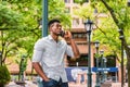 Young black man standing outdoors in New York City, talking on cell phone Royalty Free Stock Photo