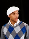 Young black man in sweater and white cap Royalty Free Stock Photo