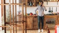 Young black man talking on mobile phone in kitchen Royalty Free Stock Photo