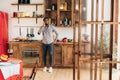 Young black man talking on mobile phone in kitchen Royalty Free Stock Photo