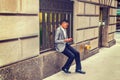 Young black Man texting on cell phone on street in New York City Royalty Free Stock Photo