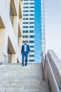 Young black man walking down stairs outside office building in New York City Royalty Free Stock Photo