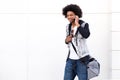 Young black man walking and talking on mobile phone Royalty Free Stock Photo