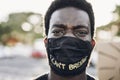 Young black man wearing face mask during equal rights protest - Concept of demonstrators on road for Black Lives Matter and I Can