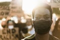 Young black man wearing face mask during equal rights protest - Concept of demonstrators on road for no racism campaign- Focus on Royalty Free Stock Photo