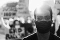 Young black man wearing face mask during equal rights protest - Concept of demonstrators on road for no racism campaign- Focus on Royalty Free Stock Photo