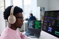 Young Black Man Wearing Headphones Working on Computer Programming Code Royalty Free Stock Photo