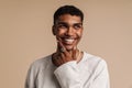 Young black man wearing rings laughing while looking at camera