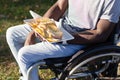 Young Black man in wheelchair having lunch Royalty Free Stock Photo