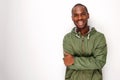 Young black man with windbreaker jacket smiling against white background