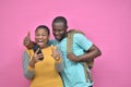 young black man and woman feeling excited and happy viewing content on a mobile phone together