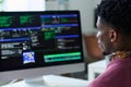 Young Black Man Working on Computer Programming Code in Office Setting Royalty Free Stock Photo