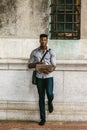 Young black man working on laptop computer on street in New York City Royalty Free Stock Photo