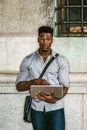 Young black man working on laptop computer on street in New York City Royalty Free Stock Photo